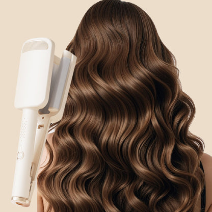 Woman with long defined French waves beside beige curling iron